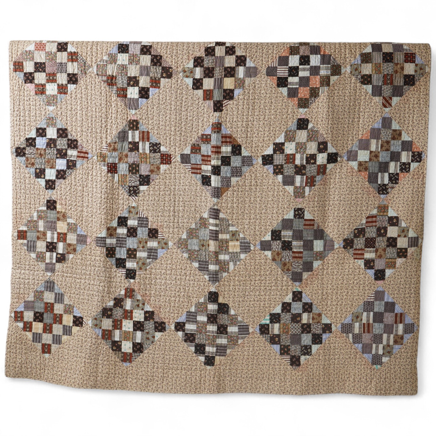 An American Kentucky 1865 (Civil War) block strip, ‘postage stamp’ hand quilted bedcover. Made from a large selection of highly fashionable madder dyed printed cottons of the day, as large concentric diamond shaped strip